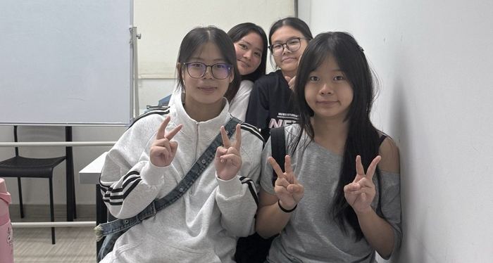 Four students at a desk in an Ember class