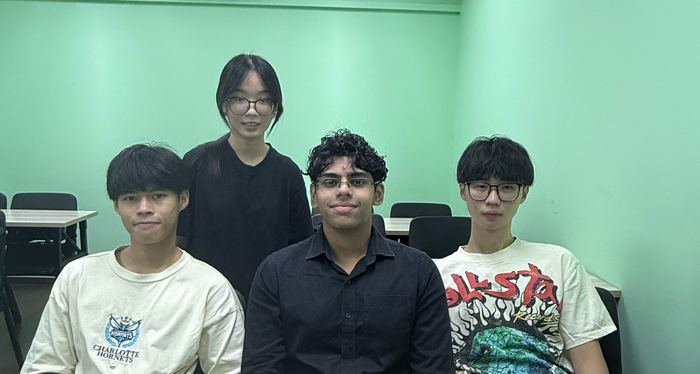 A small Ember class seated together at a desk